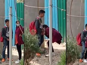 Indian woman milks in front of college
