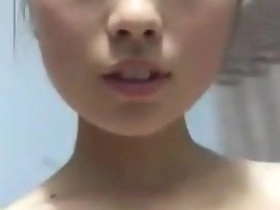 Asian woman bares her figure in a